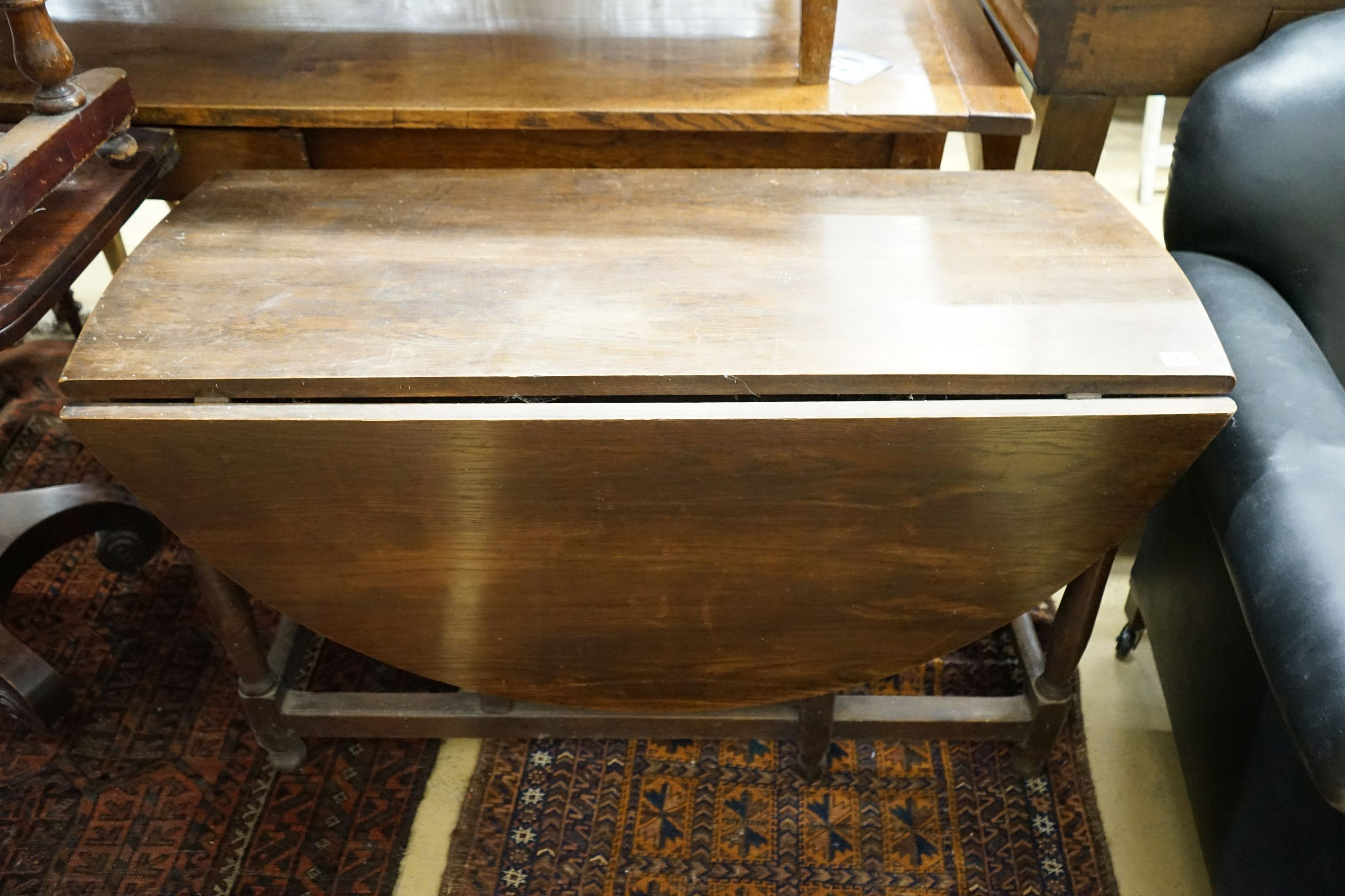 An 18th century style oak gateleg dining table, width 112cm, 140cm extended, height 68cm